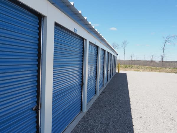 Full row of Building D units receding toward the property's back fence line