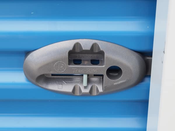 Heavy-duty latch on a roll-up storage door