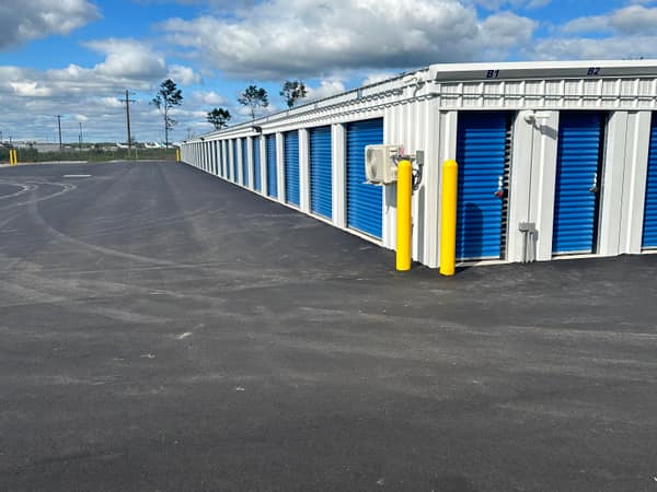 Corner of a Phase 1 building with paved drive and bollards
