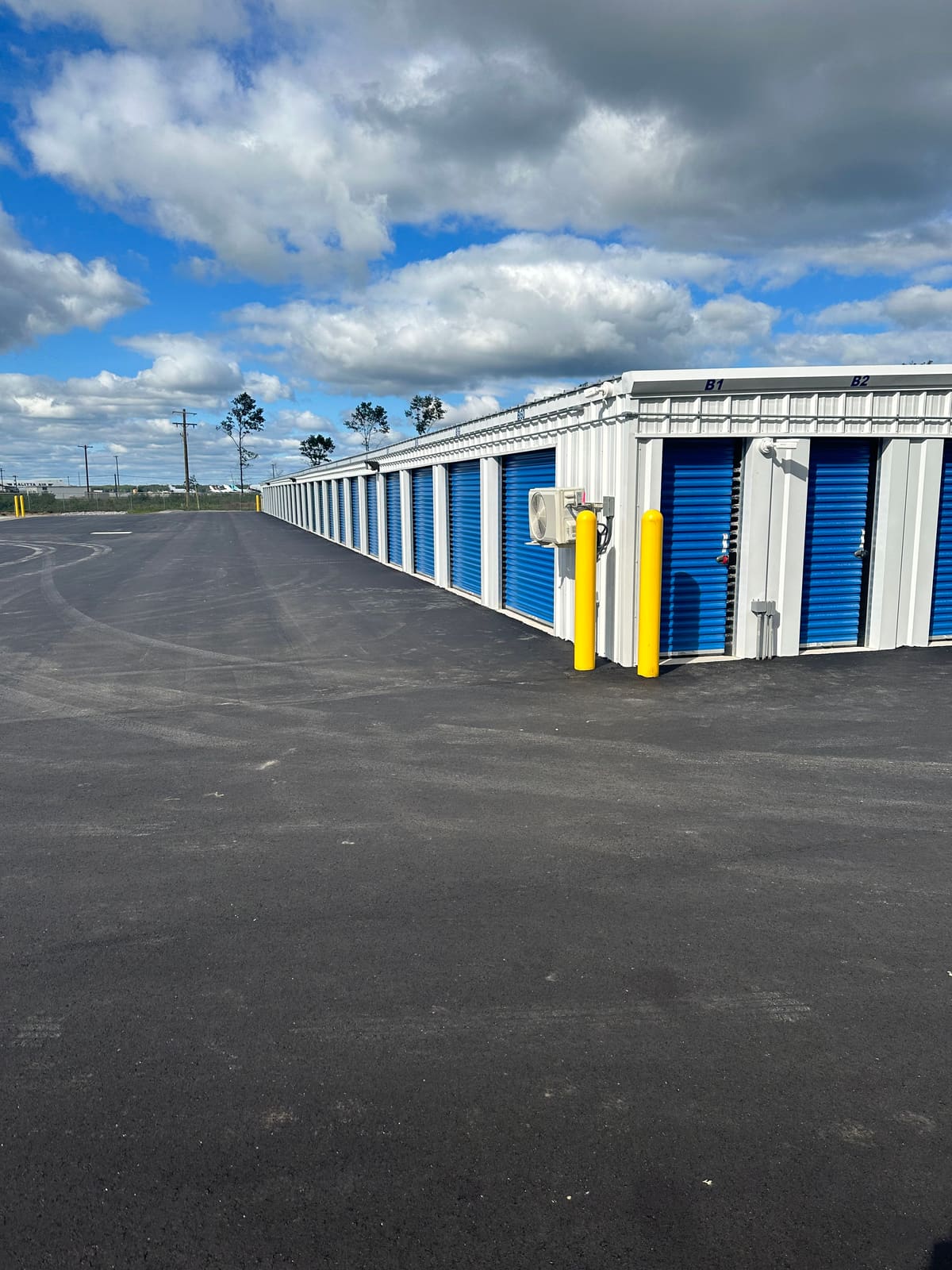 Phase 1 drive-up storage buildings with blue roll-up doors